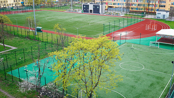 Overhead view of sprots field with 2 soccer fields and a track