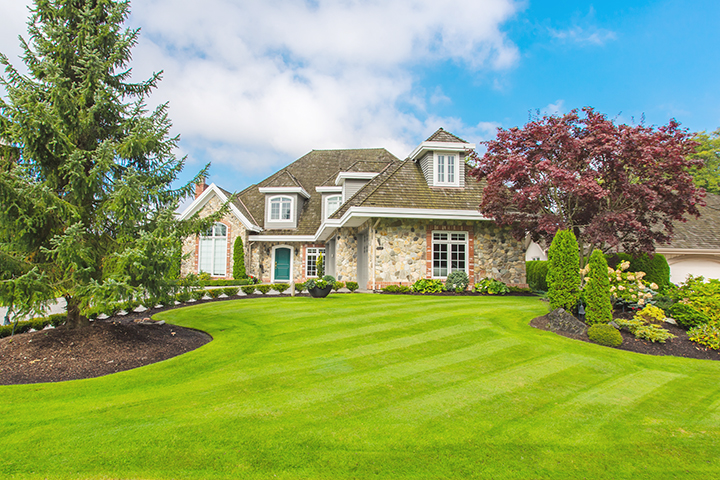 Brick house with front gardens and a freshly cut lawn