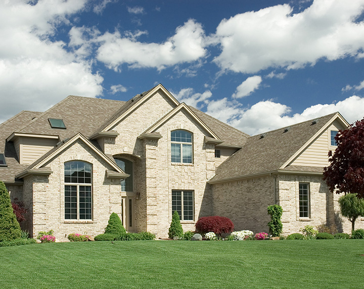 Large brick home with beautiful lush green front yard